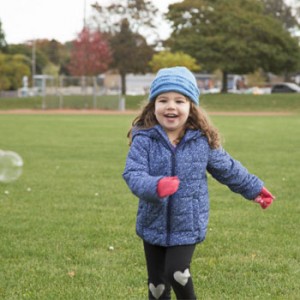 Photo of girl chasing bubbles